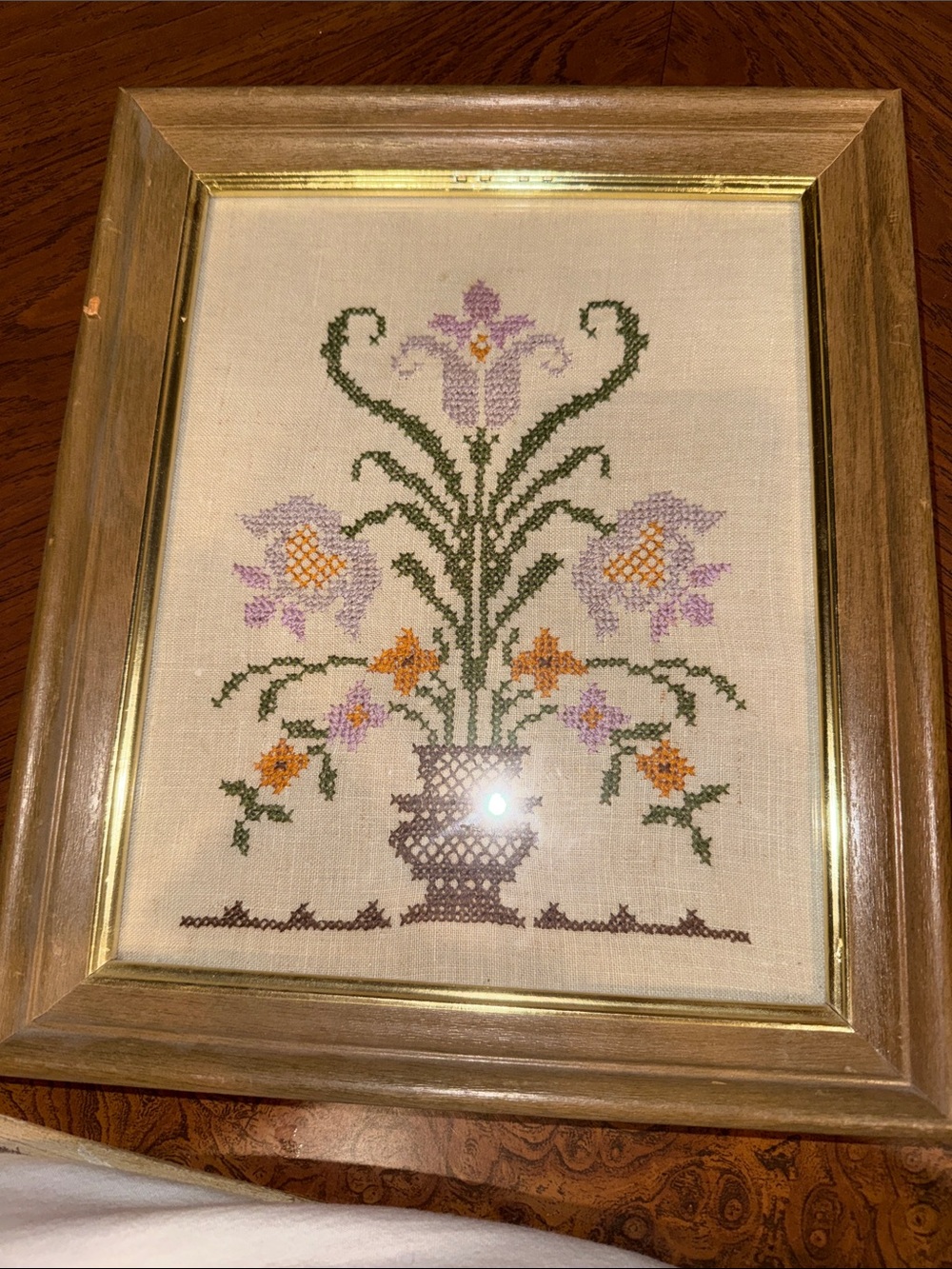 Framed Purple and Orange Floral Cross-Stitch Wall Art on Neutral linen